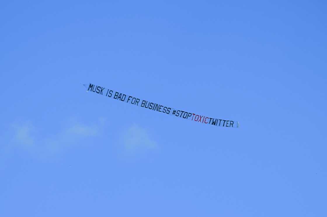 A banner reading, "Musk is Bad for Business #StopToxicTwitter" is flown over a conference venue in Miami, Florida where the Twitter CEO made a keynote address