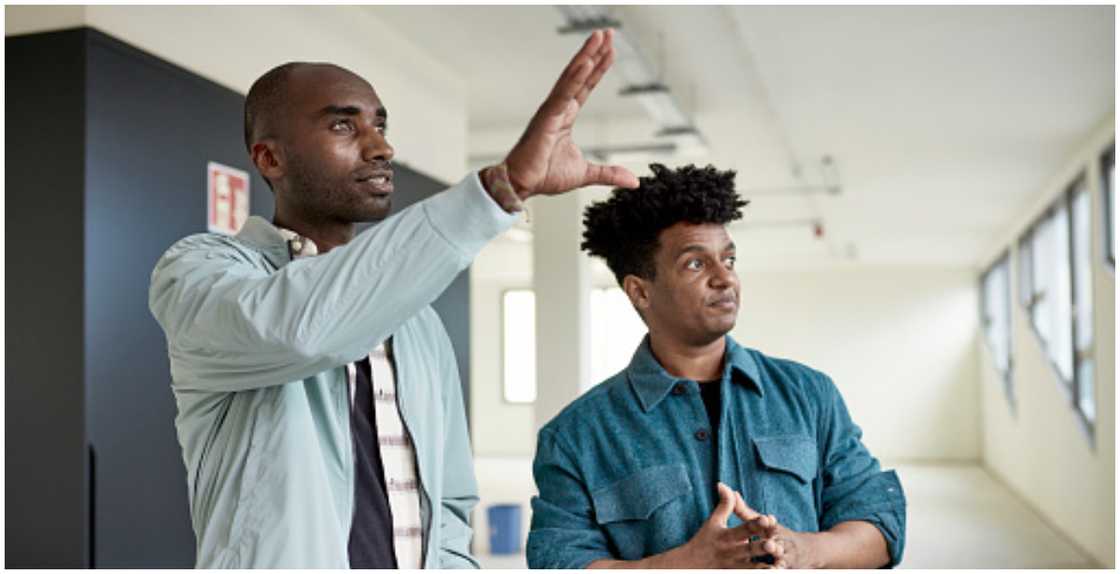 A real estate agent shows a client around a property