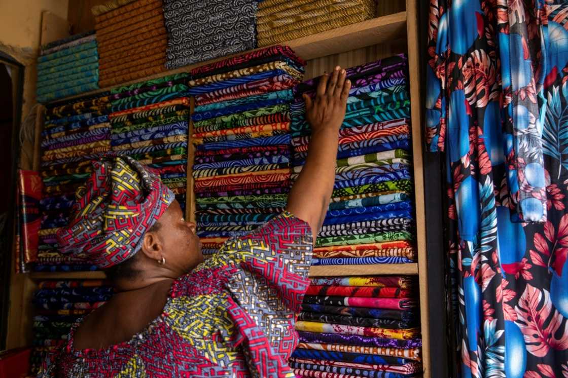 Trader Christiana Morenikeji Ilesanmi, 56, says she is selling a lot of Chinese-made adire fabrics because they are cheaper Trader Christiana Morenikeji Ilesanmi, 56, says she is selling a lot of Chinese-made adire fabrics because they are cheaper