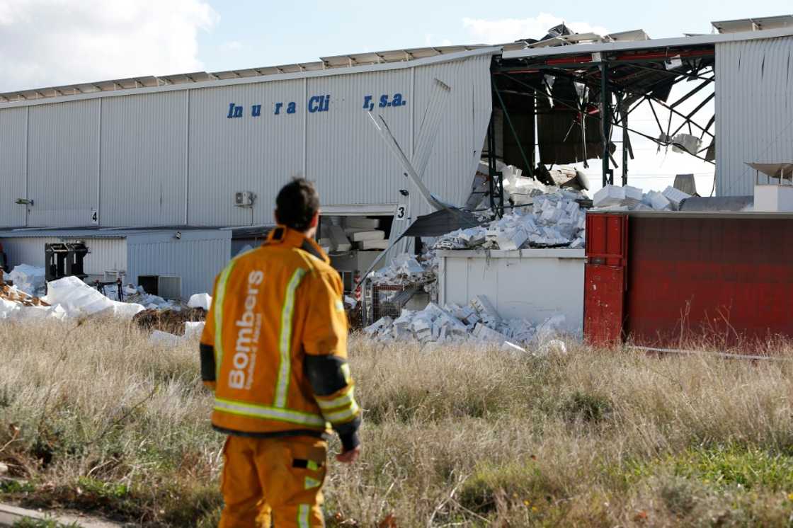 A firefighter stands next to a partially collapsed factory after an explosion killed three people in the town of Ibi A firefighter stands next to a partially collapsed factory after an explosion killed three people in the town of Ibi
