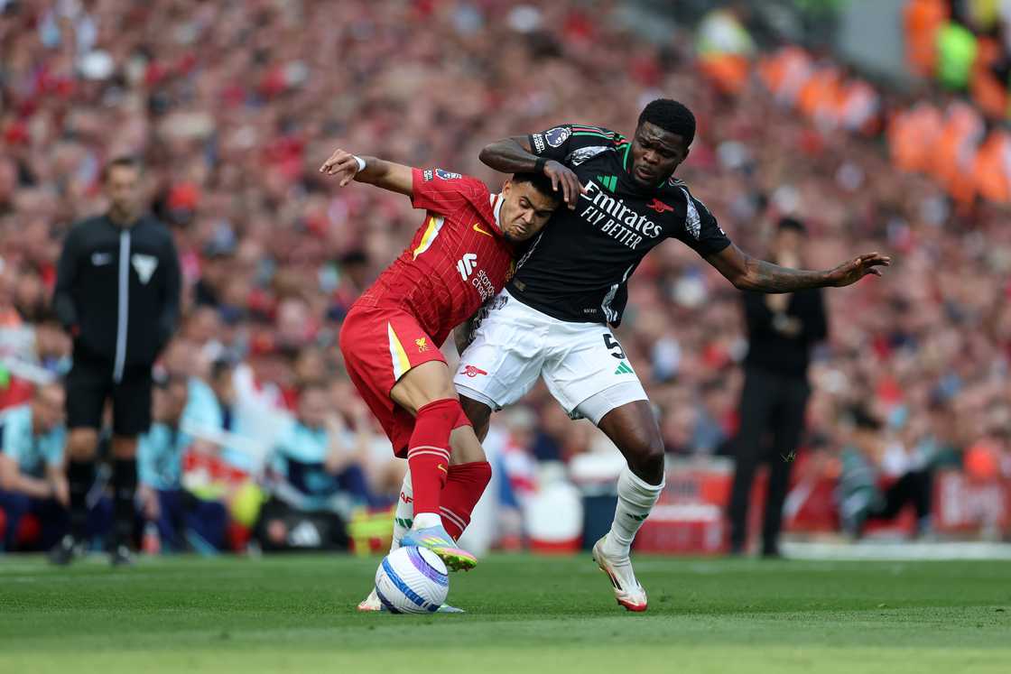 Luis Diaz of Liverpool is challenged by Thomas Partey of Arsenal during the Premier League match between Liverpool FC and Arsenal FC at Anfield on May 11, 2025 in Liverpool, England Luis Diaz of Liverpool is challenged by Thomas Partey of Arsenal during the Premier League match between Liverpool FC and Arsenal FC at Anfield on May 11, 2025 in Liverpool, England