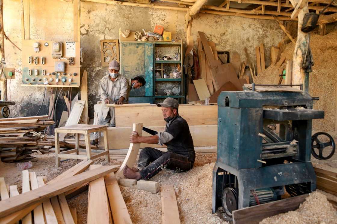 Without a reliable energy supply, carpenters use a fuel generator to keep business in operation, puffing out emissions that contribute to global warming Without a reliable energy supply, carpenters use a fuel generator to keep business in operation, puffing out emissions that contribute to global warming