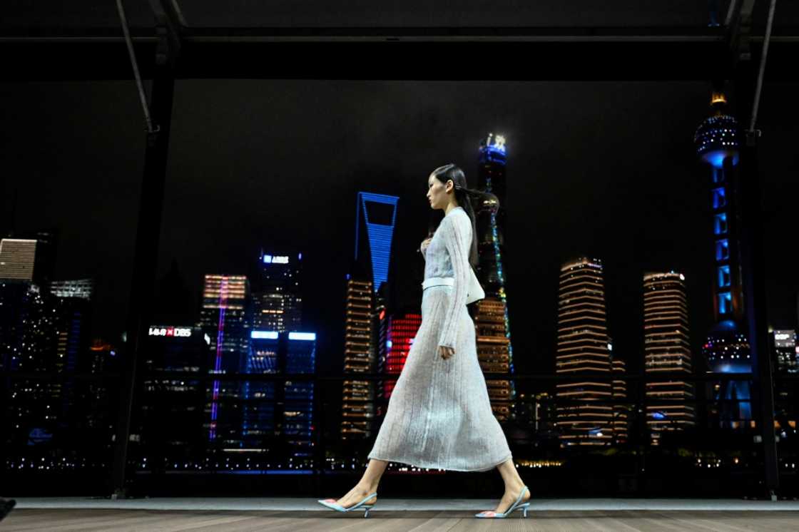 Against Shanghai's glittering river skyline, Kenzo-clad models strutted down a breezy open-air runway for the French fashion brand's first-ever show in China Against Shanghai's glittering river skyline, Kenzo-clad models strutted down a breezy open-air runway for the French fashion brand's first-ever show in China