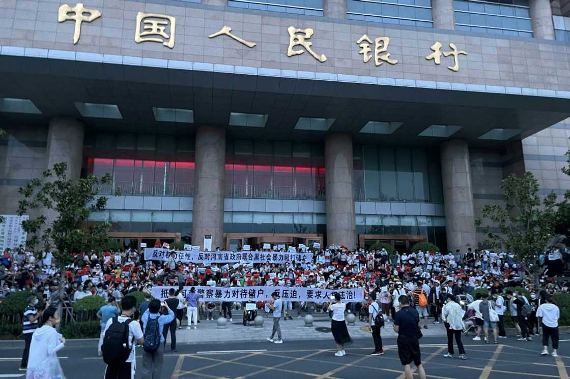 Hundreds of people rallied outside a branch of the People's Bank of China in Henan's capital Zhengzhou on Sunday demanding their money, according to multiple witnesses