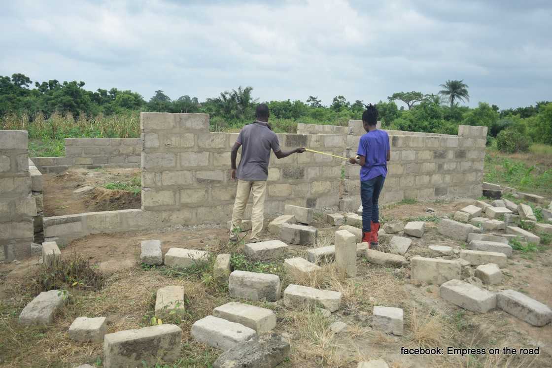 Photo of Empress Esi and a man at the site of one of her projects.