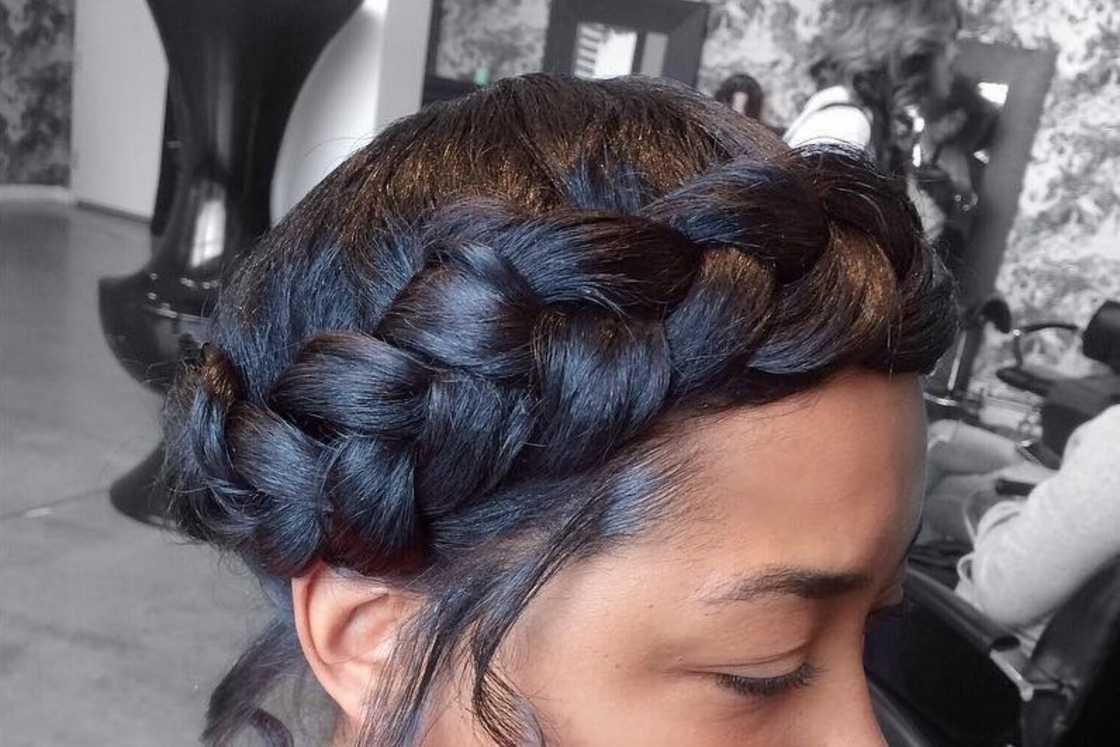 A woman is rocking a black braided crown A woman is rocking a black braided crown