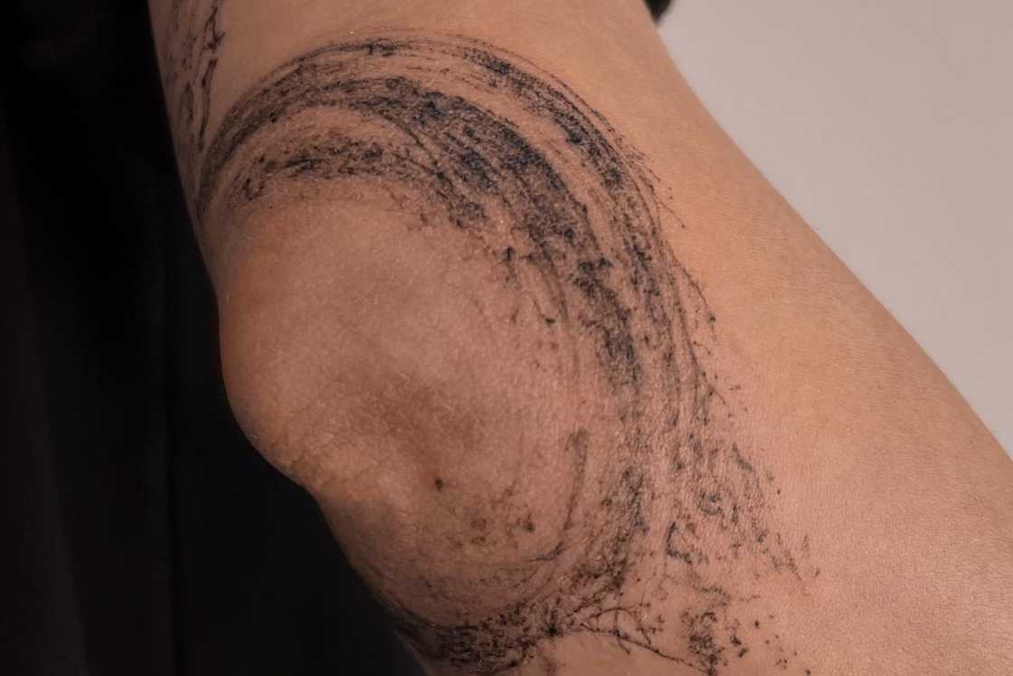 A black and grey abstract wave elbow tattoo A black and grey abstract wave elbow tattoo