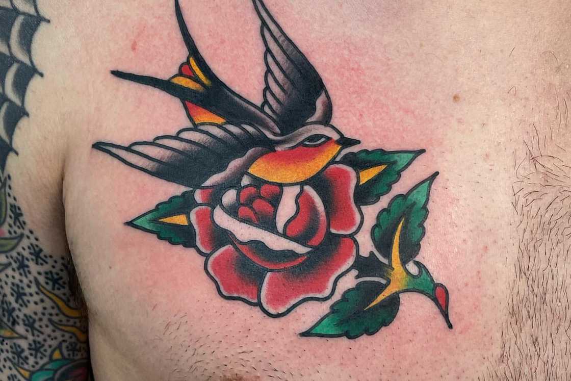 A colourful small chest rose tattoo A colourful small chest rose tattoo