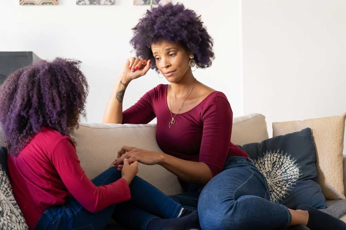 A mother talking with her duaghter indoors