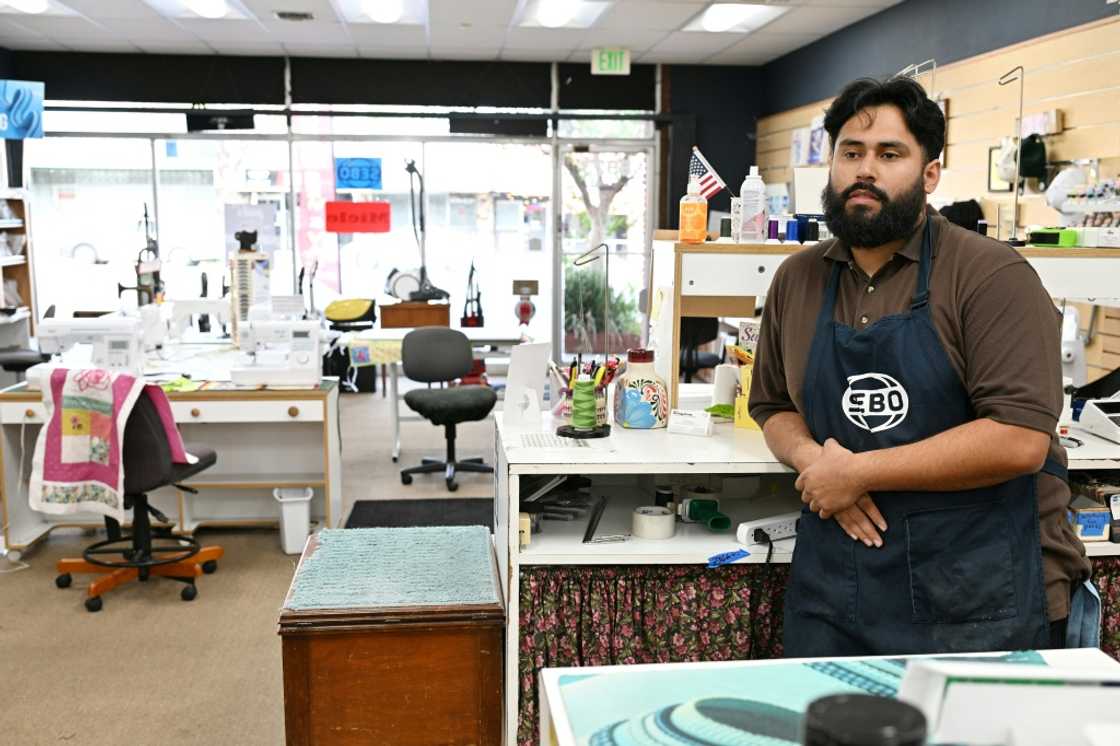 Angel De Luna waits for customers at his family-owned Kingdom Sewing & Vacuum Center, where the tariffs are shaping up to be a threat to businesses like his Angel De Luna waits for customers at his family-owned Kingdom Sewing & Vacuum Center, where the tariffs are shaping up to be a threat to businesses like his