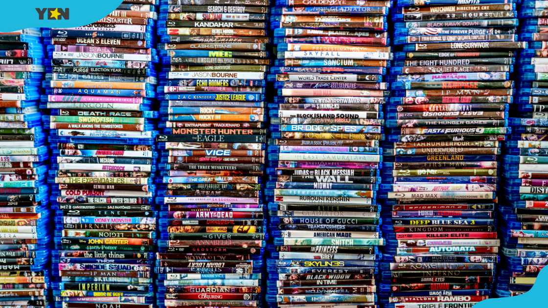 A close-up of Blu-ray movie discs on a shelf. A close-up of Blu-ray movie discs on a shelf.