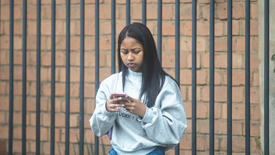 A worried woman checking something on her phone