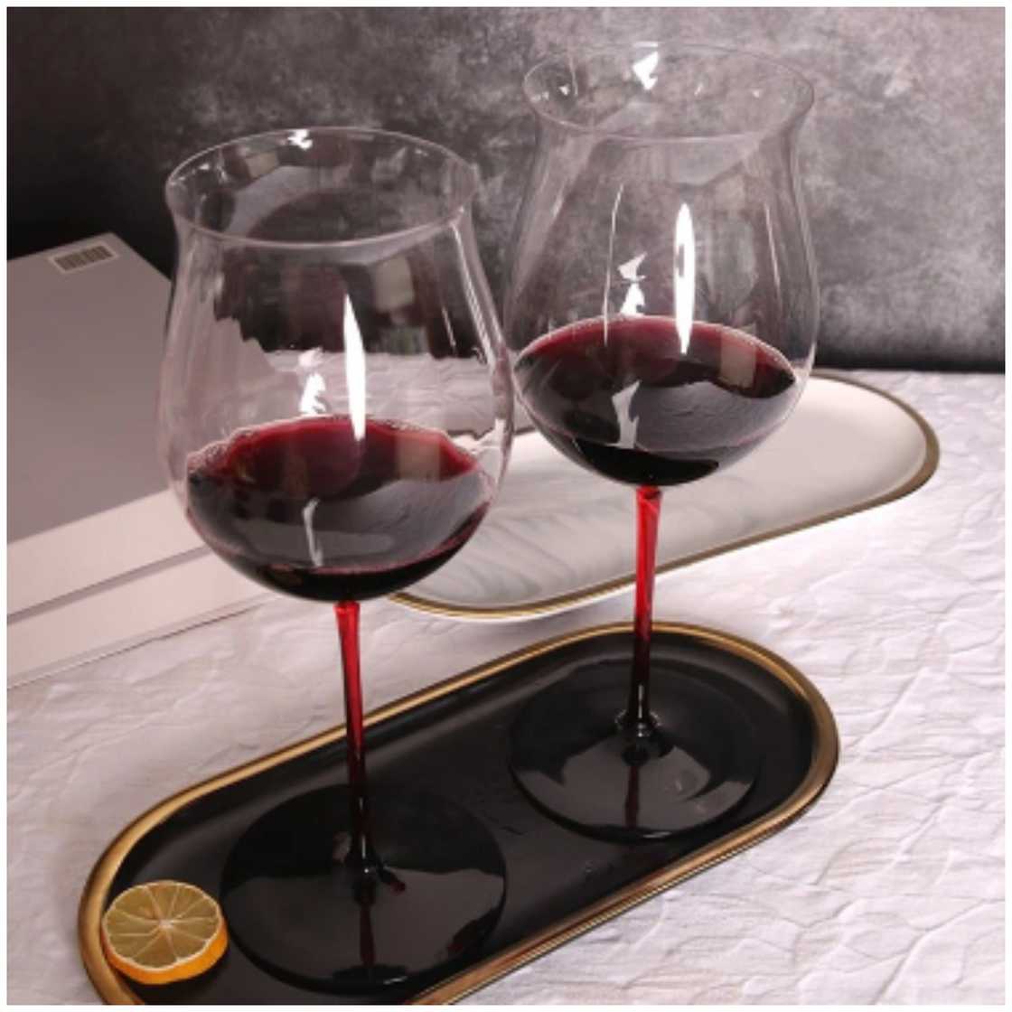 Two burgundy glasses on a serving tray Two burgundy glasses on a serving tray