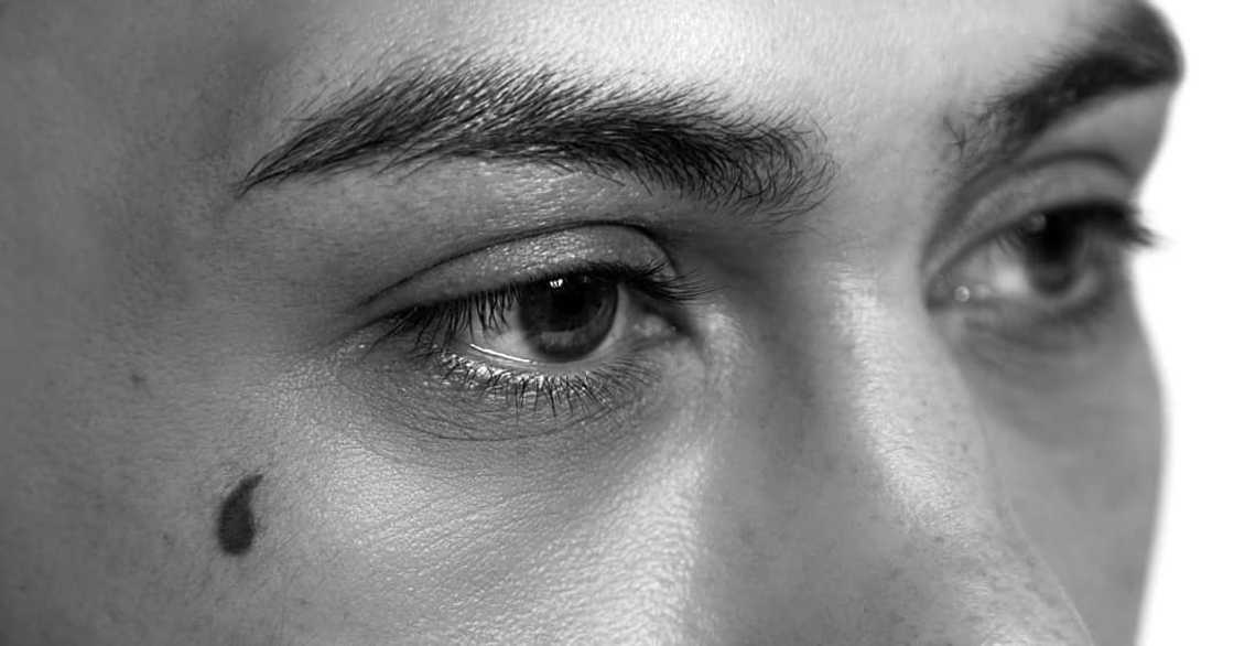 A filled-in teardrop tattoo A filled-in teardrop tattoo