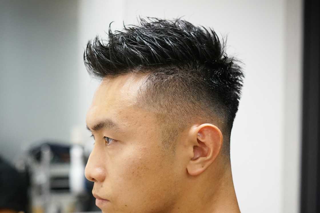 Faux hawk haircut with a mid fade