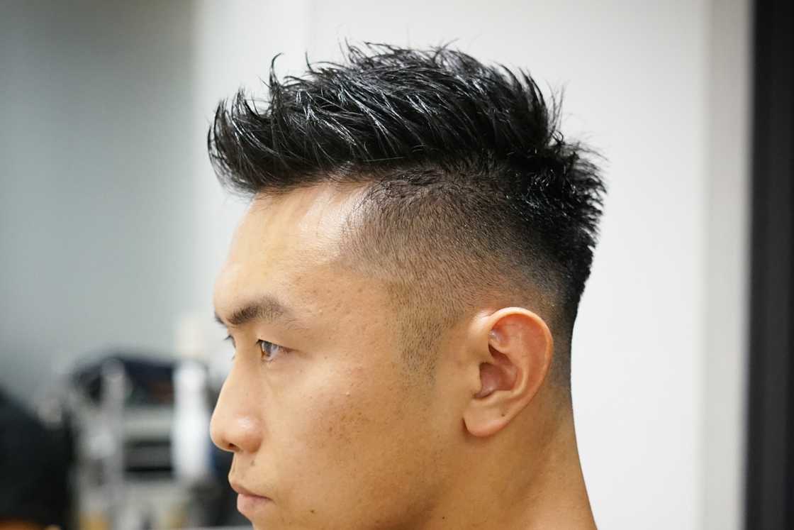 Faux hawk haircut with a mid fade Faux hawk haircut with a mid fade
