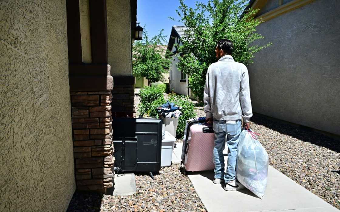 A man and his family gather their belongings after being evicted from a residential property A man and his family gather their belongings after being evicted from a residential property