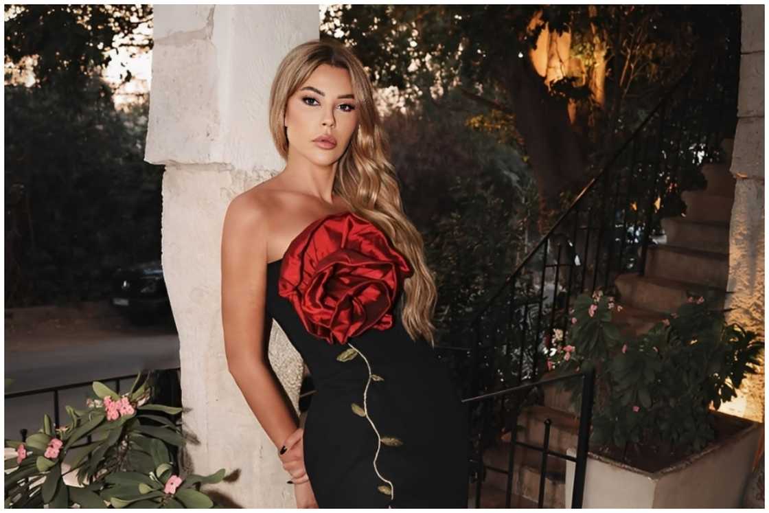 Carla posing for a picture in a black dress. Carla posing for a picture in a black dress.