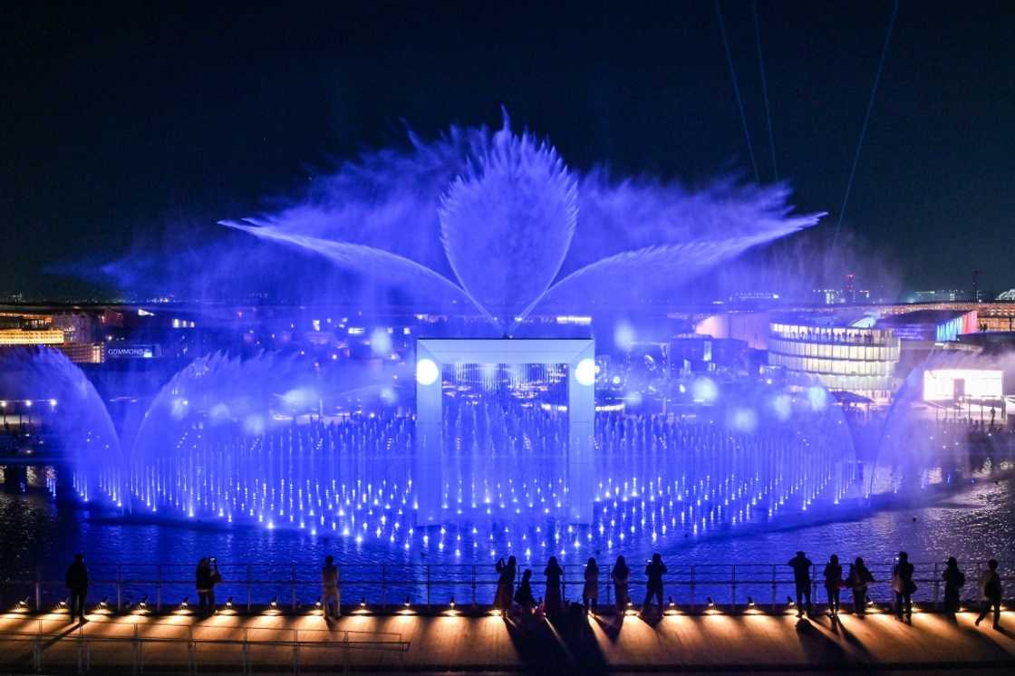 Visitors watch a water and light display during a media preview day for the 2025 Osaka Expo in Osaka on April 9, 2025 Visitors watch a water and light display during a media preview day for the 2025 Osaka Expo in Osaka on April 9, 2025