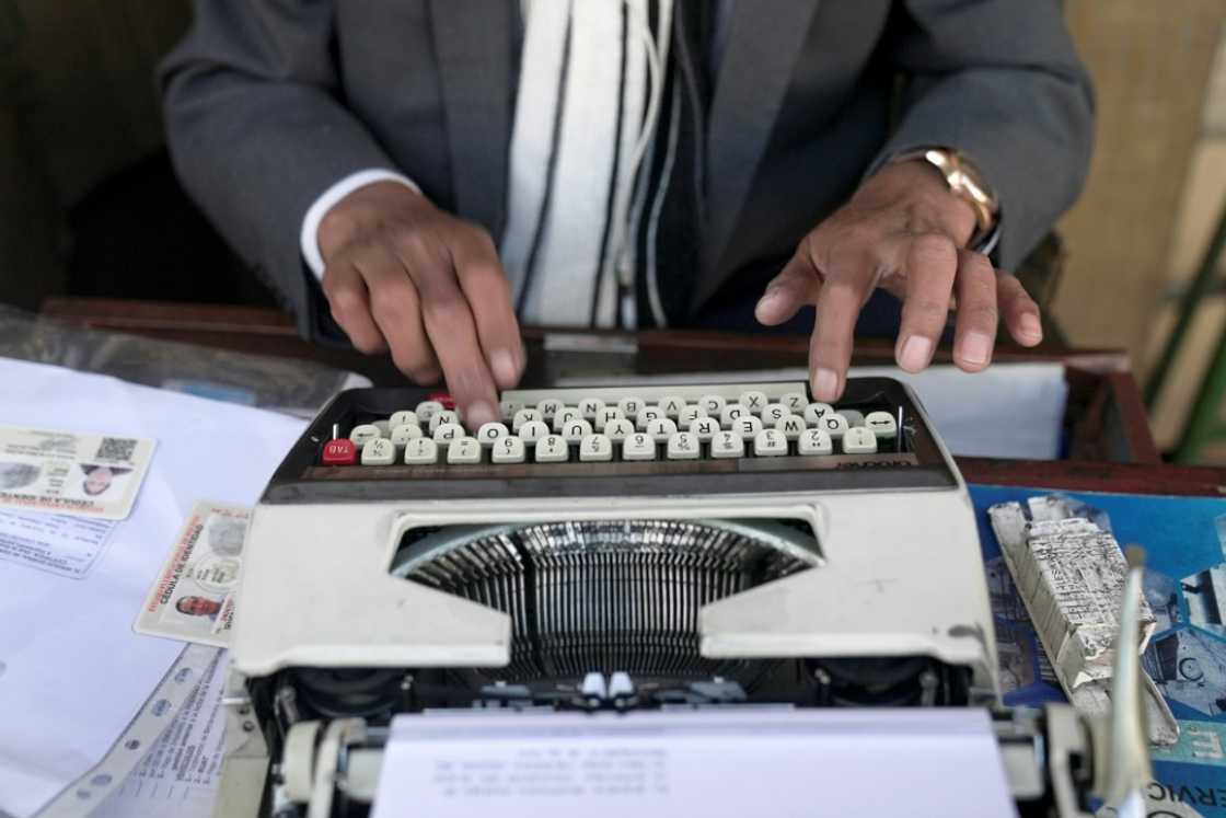 Rogelio Condori uses a typewriter on the street in La Paz, Bolivia to fill out paperwork for clients Rogelio Condori uses a typewriter on the street in La Paz, Bolivia to fill out paperwork for clients