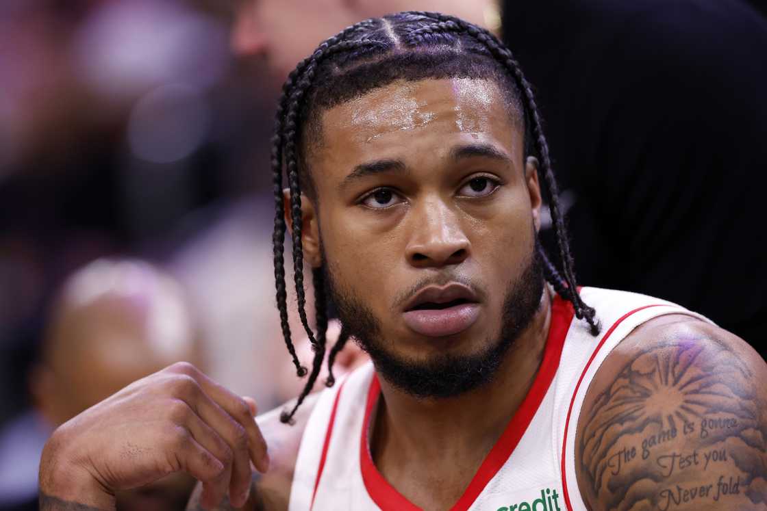 Cam Whitmore of the Houston Rockets sits on the bench during the game against the Phoenix Suns