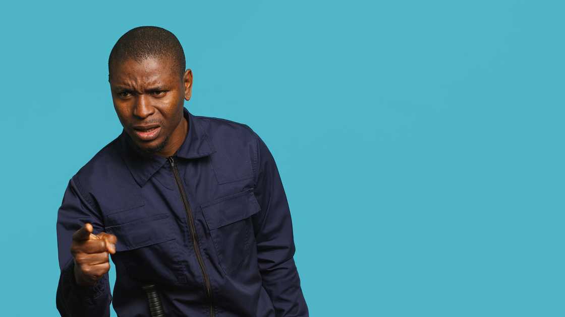 A bored security guard pointing A bored security guard pointing