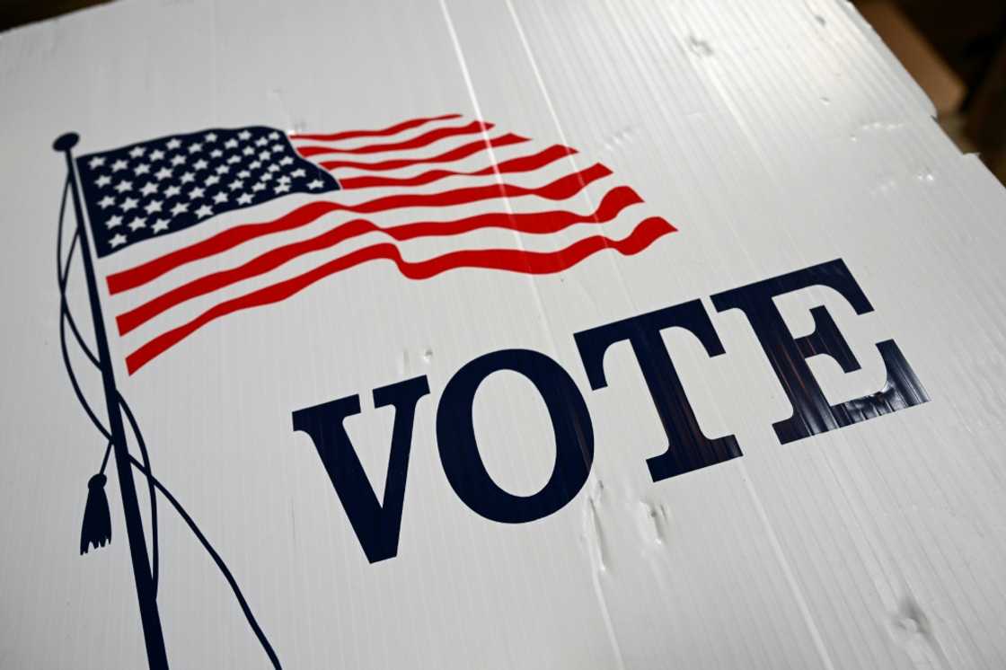 A sign with a US flag is seen at a polling station during early voting ahead of the US midterm elections in Los Angeles, California, on November 1, 2022 A sign with a US flag is seen at a polling station during early voting ahead of the US midterm elections in Los Angeles, California, on November 1, 2022