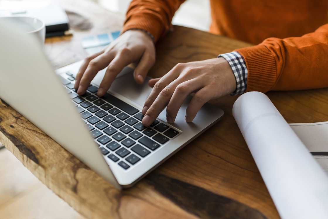 A man typing on a laptop