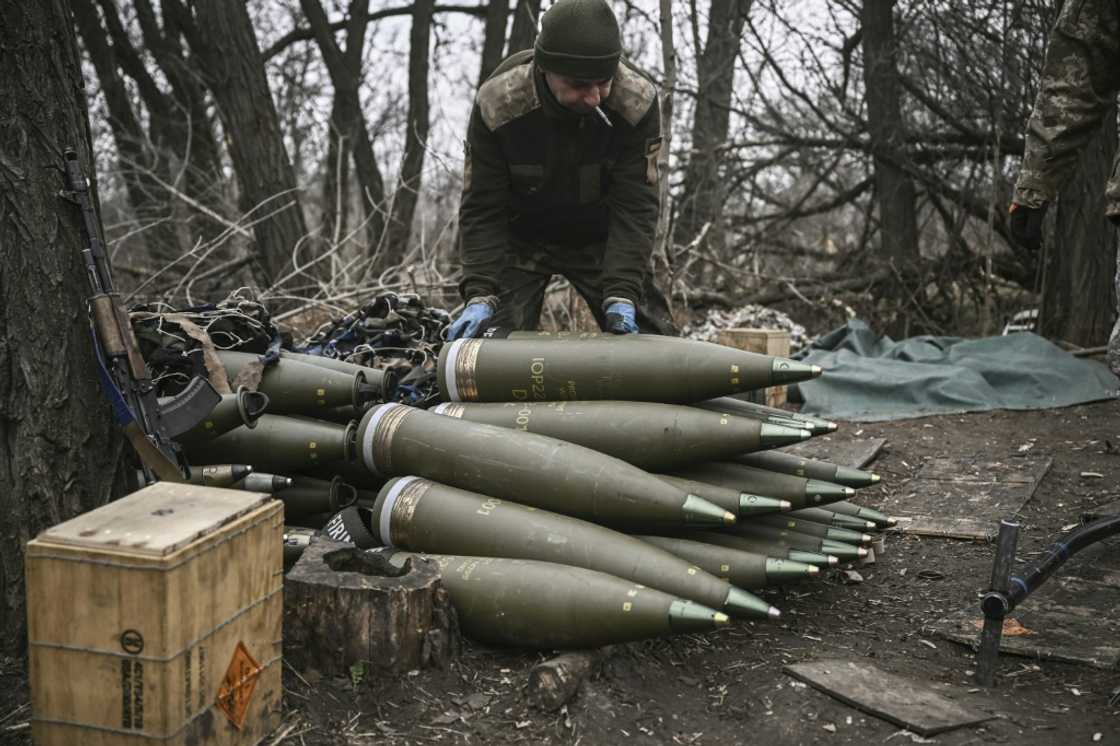 A Ukrainian serviceman preparing 155mm artillery shells near Bakhmut, eastern Ukraine. Kyiv has complained its forces are having to ration their firepower
