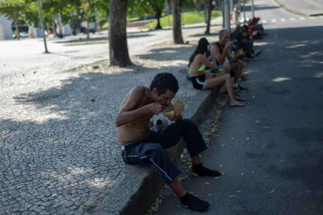 A homeless man eats a meal donated by Brazilian chef Carlos Alberto da Silva, known as Nego Breu, and his team in the Lapa neighborhood in Rio de Janeiro A homeless man eats a meal donated by Brazilian chef Carlos Alberto da Silva, known as Nego Breu, and his team in the Lapa neighborhood in Rio de Janeiro