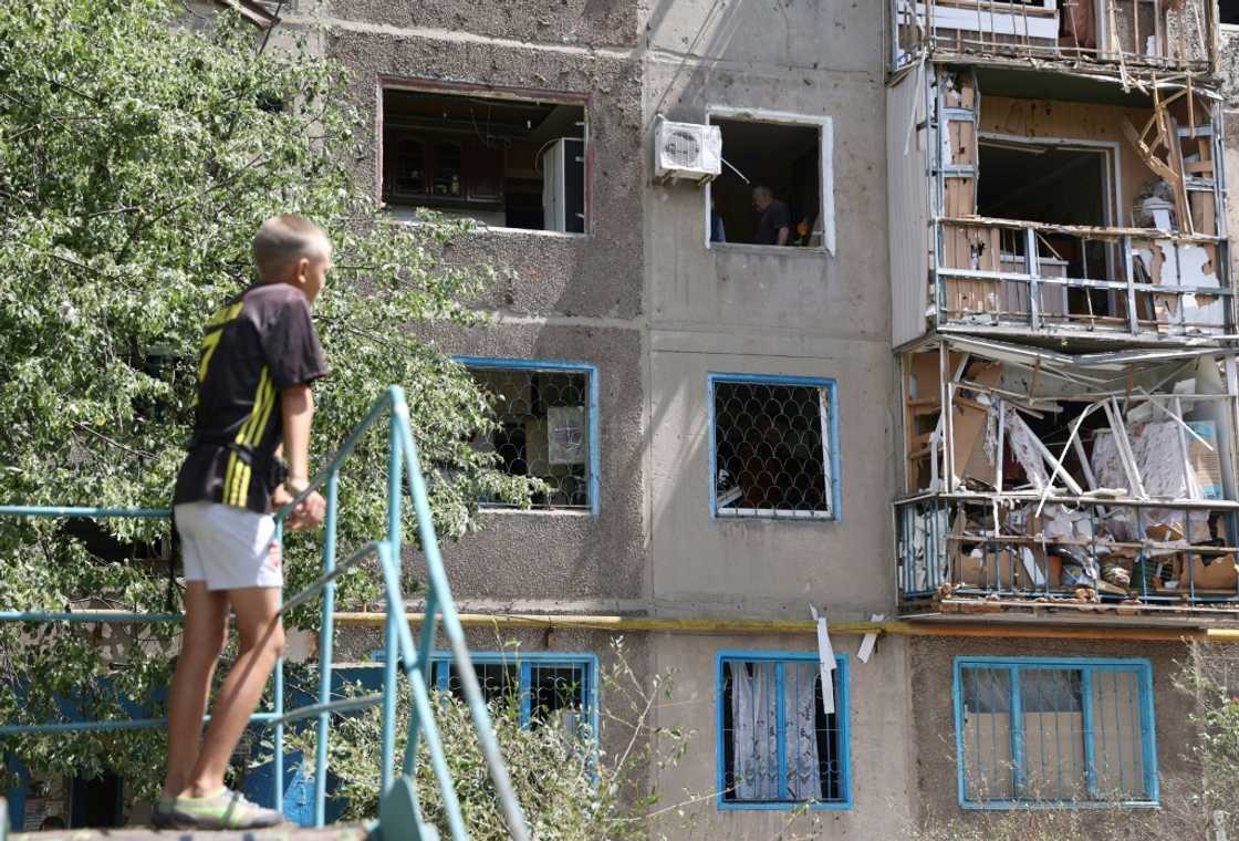 A boy surveys a damaged block of flats in Konstantinovka, hit three times in recent days as Russia intensifies its eastern offensive A boy surveys a damaged block of flats in Konstantinovka, hit three times in recent days as Russia intensifies its eastern offensive