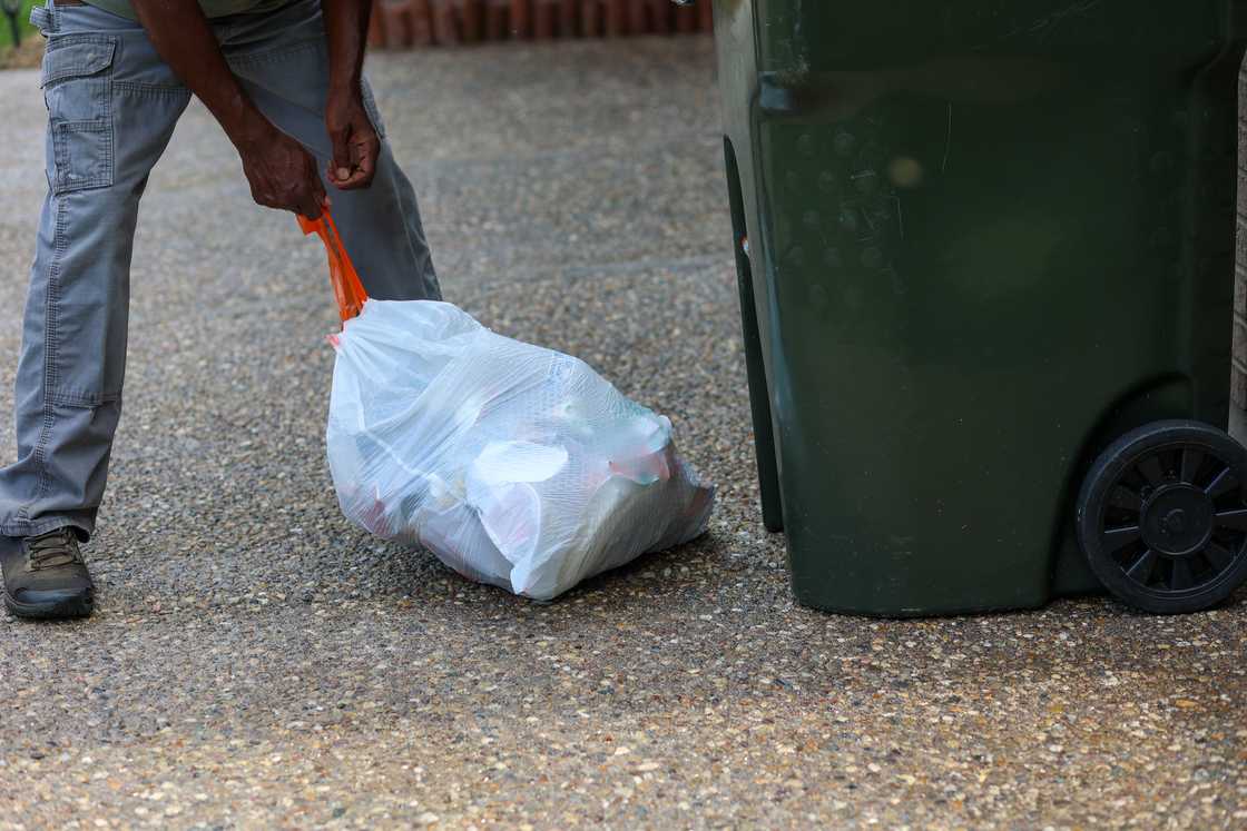 A man takes out trash A man takes out trash