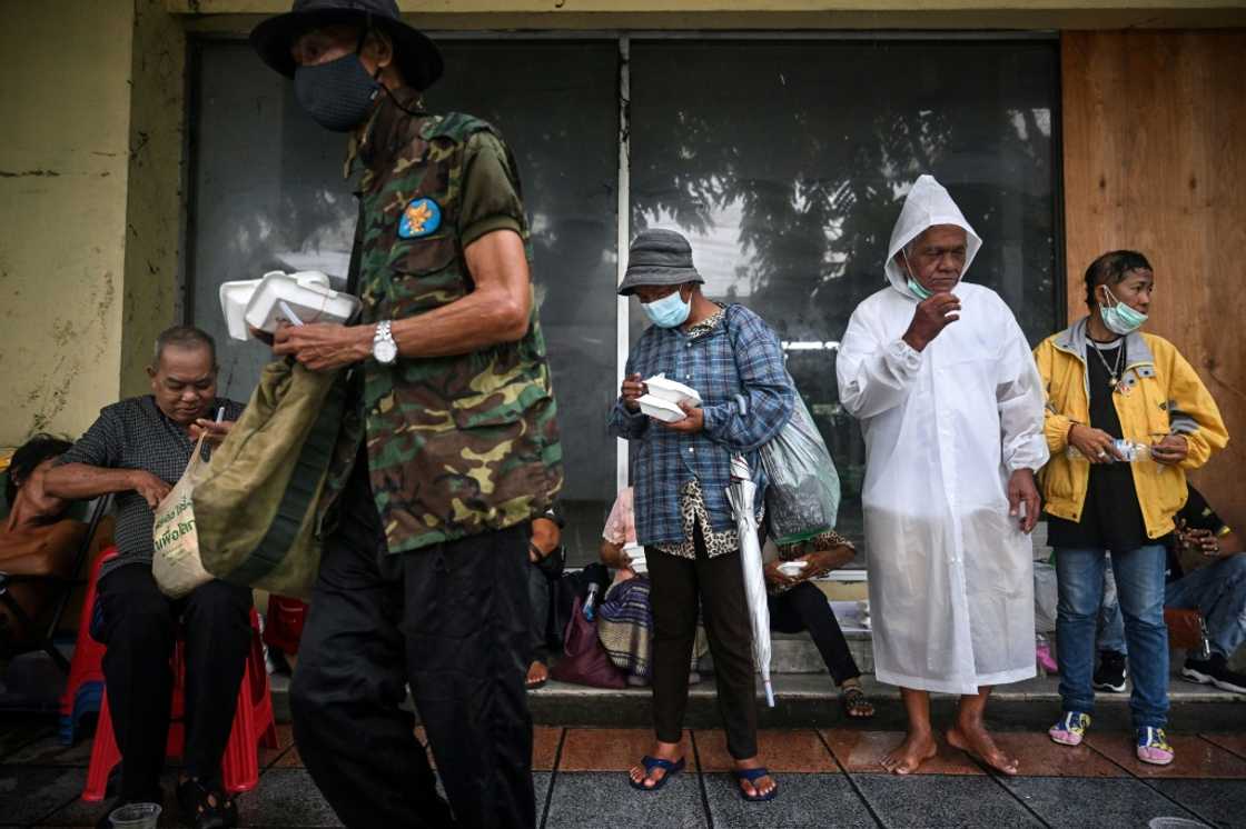 Unemployed Thais queue alongside homeless people waiting for free meals in Bangkok Unemployed Thais queue alongside homeless people waiting for free meals in Bangkok