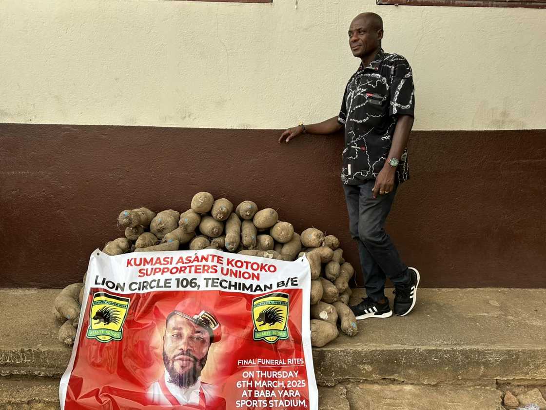 Mr. Armstrong, a top official of the Lions Circle 106 of Asante Kotoko in Techiman poses besides the 100 pieces of yam donated to assist Pooley's funeral Mr. Armstrong, a top official of the Lions Circle 106 of Asante Kotoko in Techiman poses besides the 100 pieces of yam donated to assist Pooley's funeral