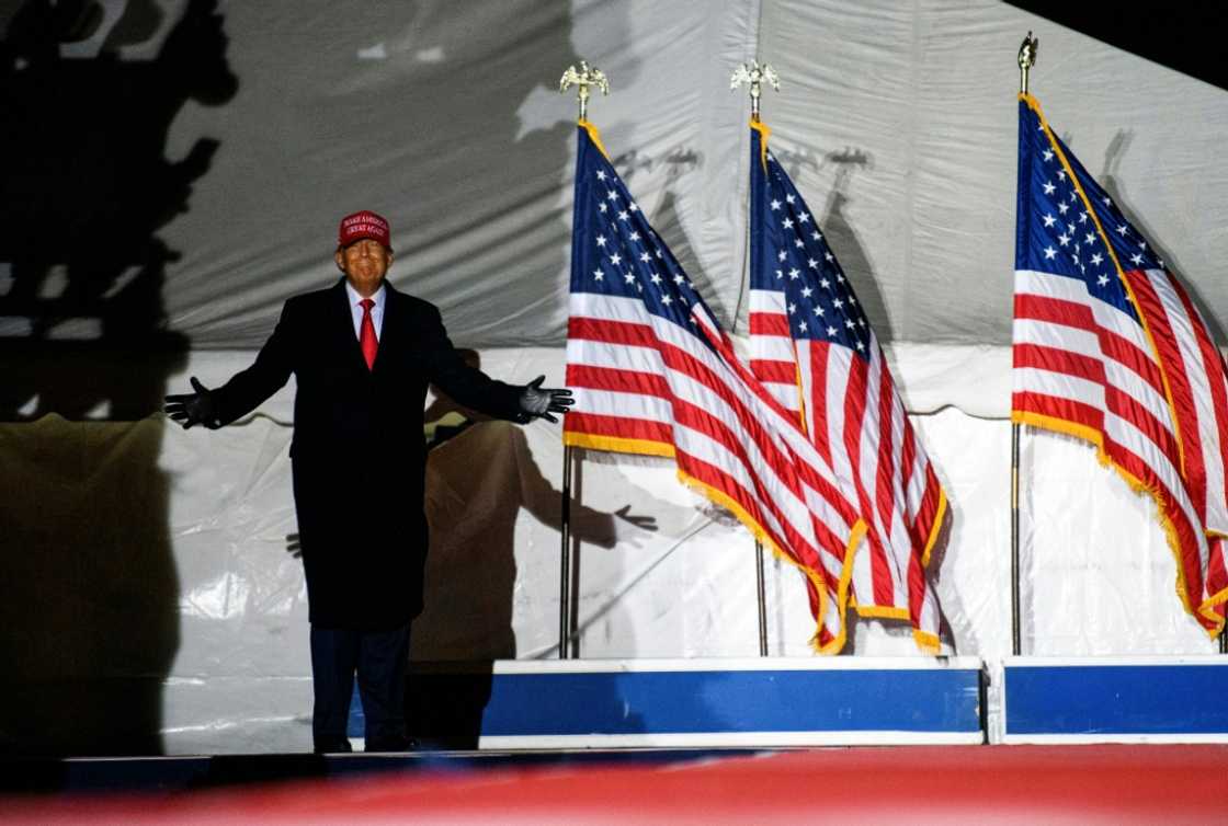 Former US president Donald Trump arrives during a campaign event at Sioux Gateway Airport on November 3, 2022 in Sioux City, Iowa Former US president Donald Trump arrives during a campaign event at Sioux Gateway Airport on November 3, 2022 in Sioux City, Iowa
