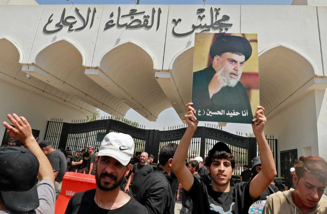 Supporters of Shiite cleric Moqtada Sadr, parade his portrait as they launch a sit-in outside the Baghdad headquarters of Iraq's top judicial body Supporters of Shiite cleric Moqtada Sadr, parade his portrait as they launch a sit-in outside the Baghdad headquarters of Iraq's top judicial body