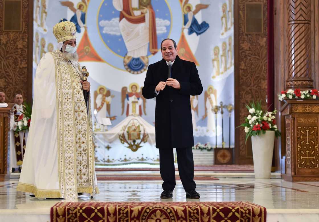 President Abdel Fattah al-Sisi alongside Pope Tawadros II during a Coptic Orthodox Christmas Eve mass at the Nativity of Christ Cathedral in Egypt's administrative capital east of Cairo on January 6, 2022 President Abdel Fattah al-Sisi alongside Pope Tawadros II during a Coptic Orthodox Christmas Eve mass at the Nativity of Christ Cathedral in Egypt's administrative capital east of Cairo on January 6, 2022