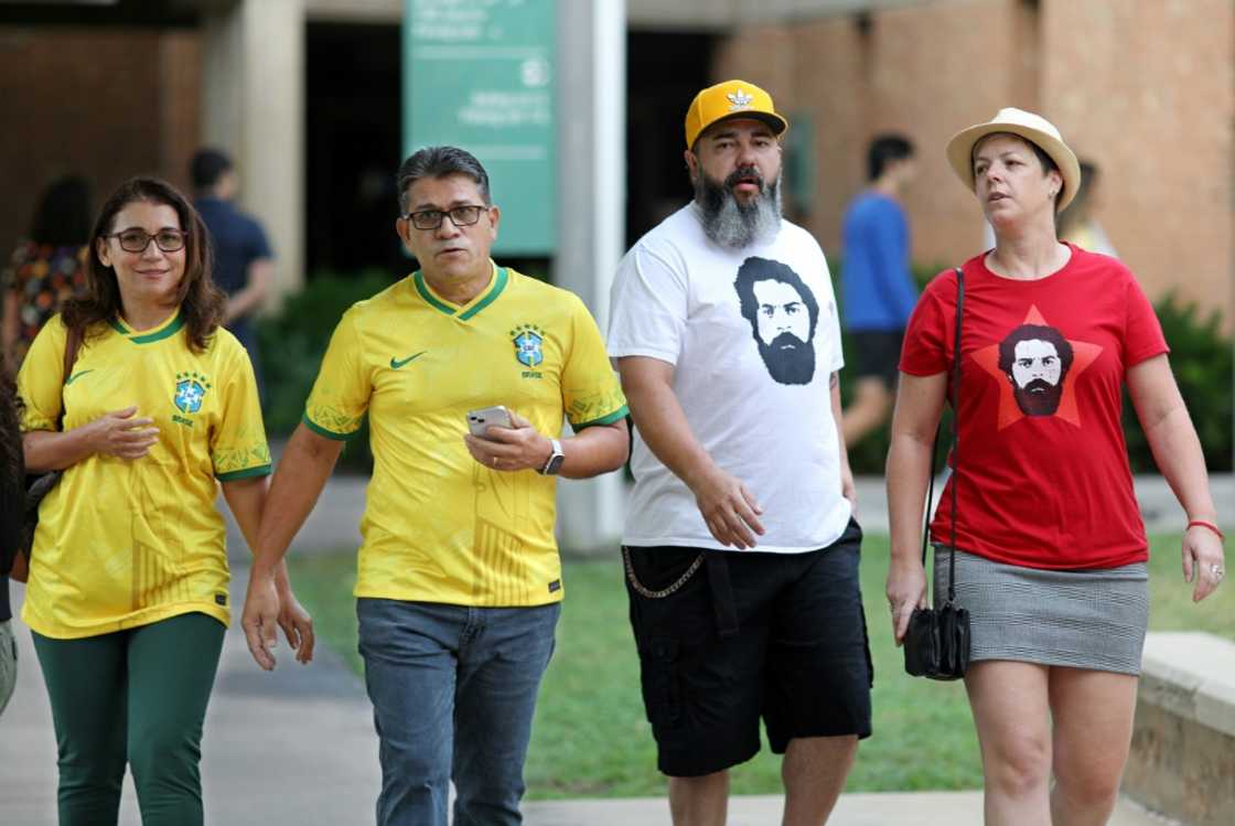 Brazilian nationals wearing pro-Lula T-shirts and Bolsonaro's favored yellow and green cast absentee ballots in Orlando, Florida Brazilian nationals wearing pro-Lula T-shirts and Bolsonaro's favored yellow and green cast absentee ballots in Orlando, Florida