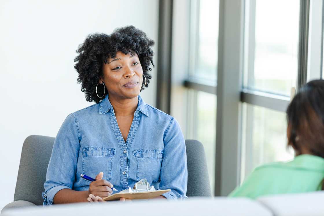 The counselor takes notes