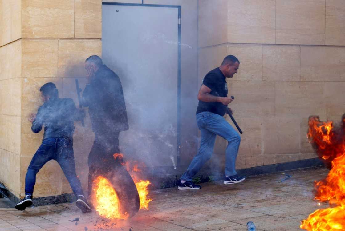 Lebanese protesters clash with bank guards in Beirut during a demonstration on May 9, 2023 Lebanese protesters clash with bank guards in Beirut during a demonstration on May 9, 2023