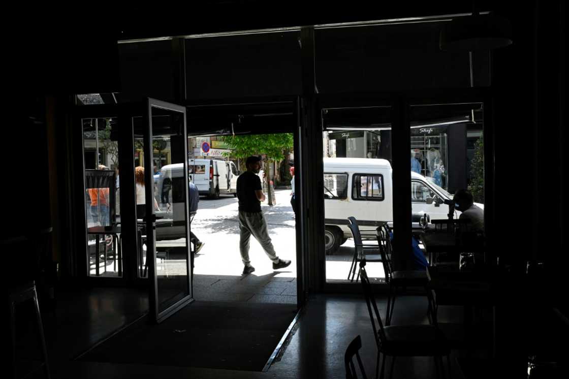 Locals outside a closed bar in Vigo, northwestern Spain, during the blackout Locals outside a closed bar in Vigo, northwestern Spain, during the blackout