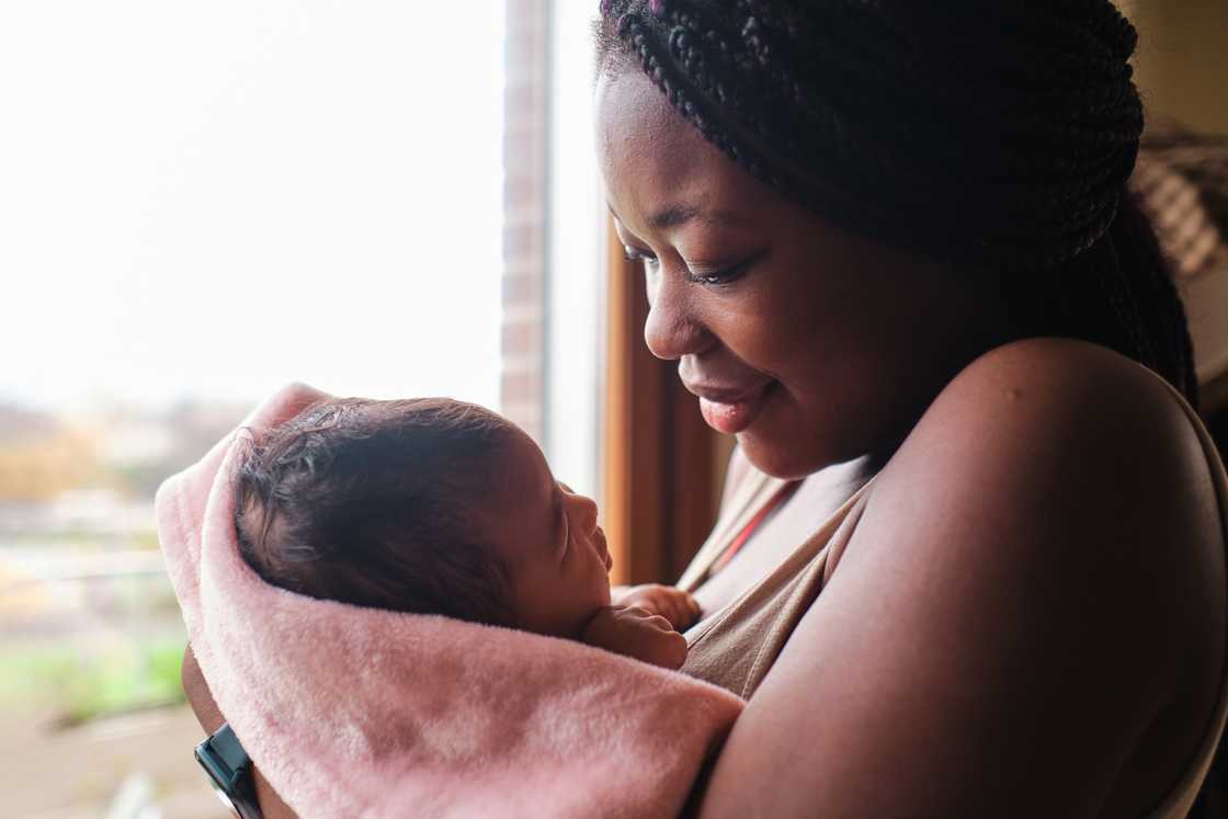 A mother holds her newborn baby.