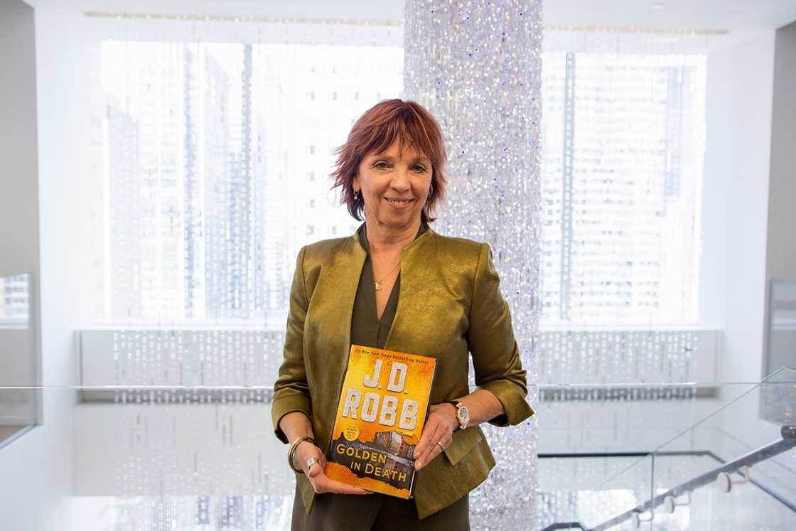 J.D. ROBB is holding the Golden In Death book J.D. ROBB is holding the Golden In Death book