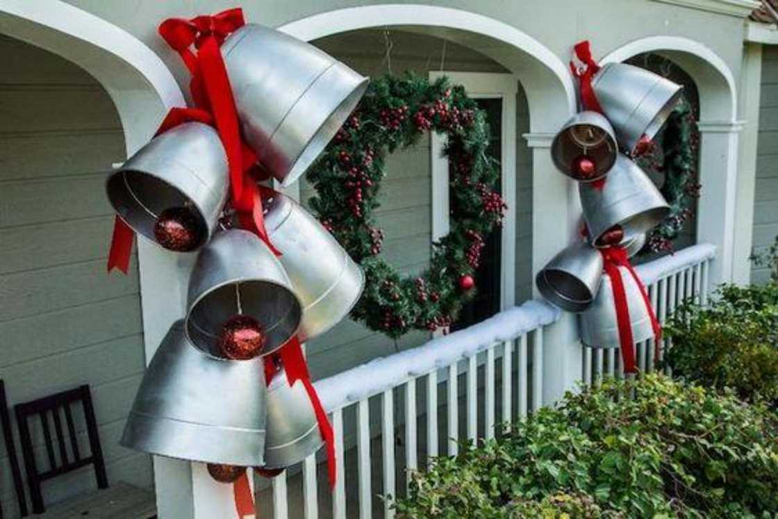 Oversized bells with red ribbons and wreath at the centre