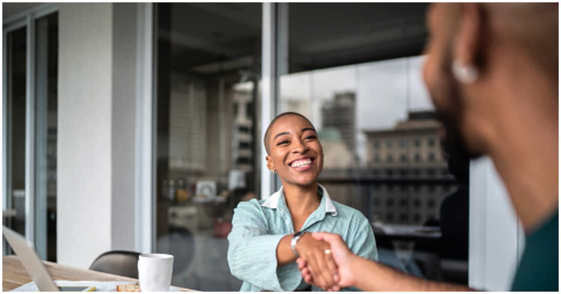 A real estate agent shaking hands with a client