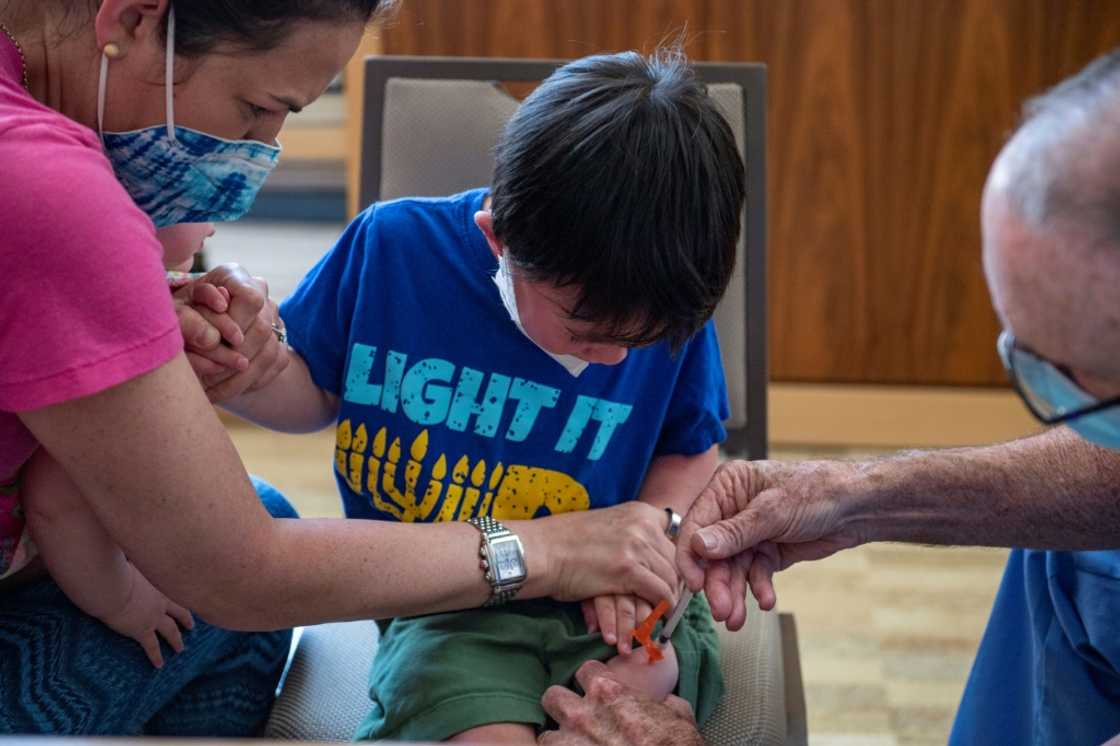 A three year old receives his Covid-19 vaccination, with Moderna, at Temple Beth Shalom in Needham, Massachusetts on June 21, 2022 A three year old receives his Covid-19 vaccination, with Moderna, at Temple Beth Shalom in Needham, Massachusetts on June 21, 2022
