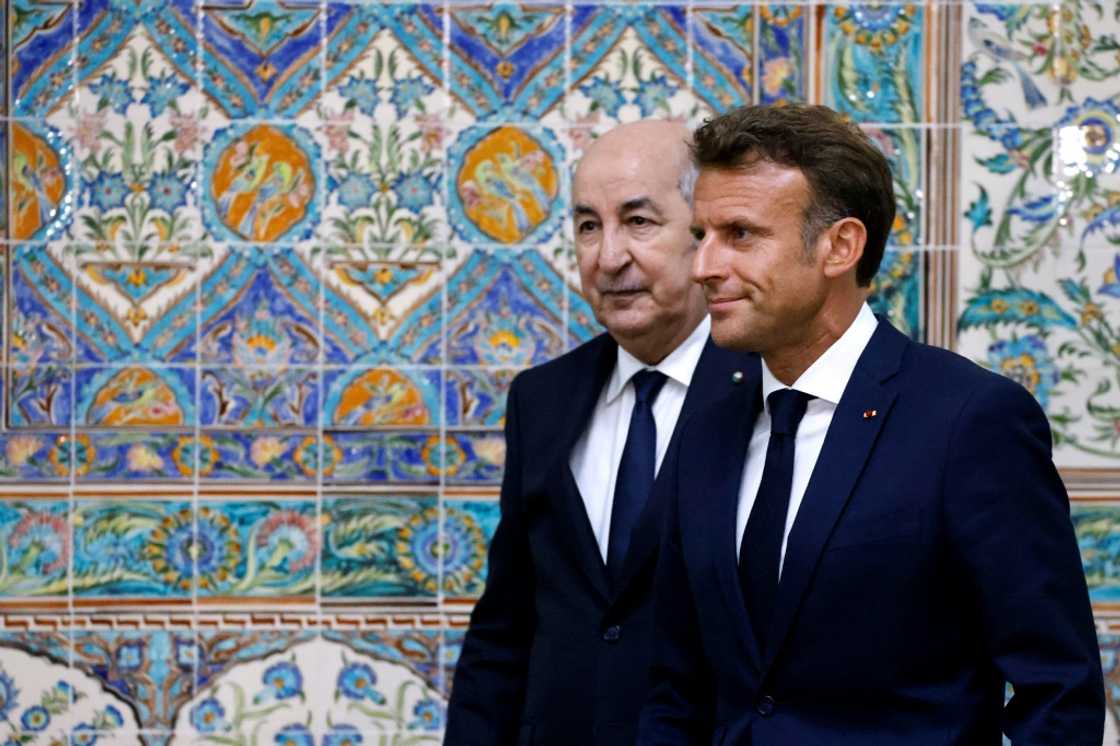 French President Emmanuel Macron (R) and Algeria's President Abdelmadjid Tebboune (L) leave at the end of a joint press conference at the presidential palace in Algiers on August 25, 2022 French President Emmanuel Macron (R) and Algeria's President Abdelmadjid Tebboune (L) leave at the end of a joint press conference at the presidential palace in Algiers on August 25, 2022