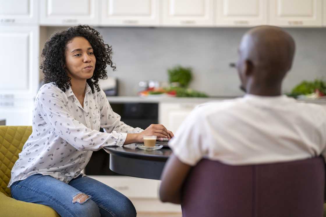 A man and woman talking in a cafe