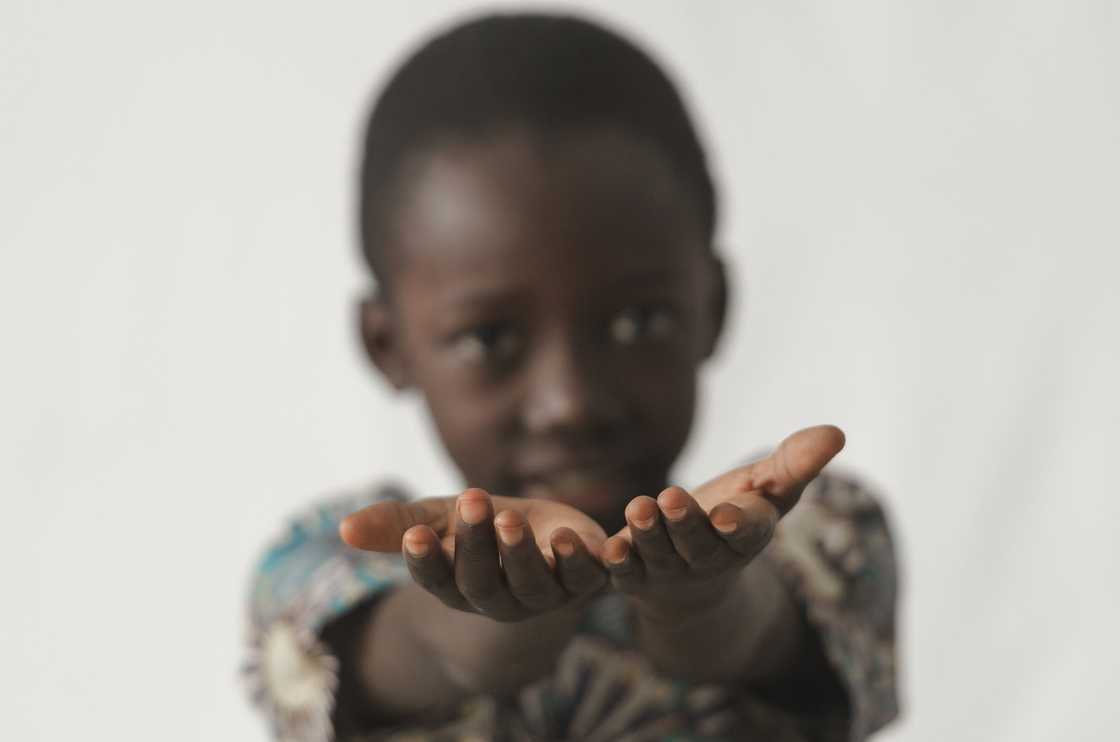 African boy holding his hands open African boy holding his hands open