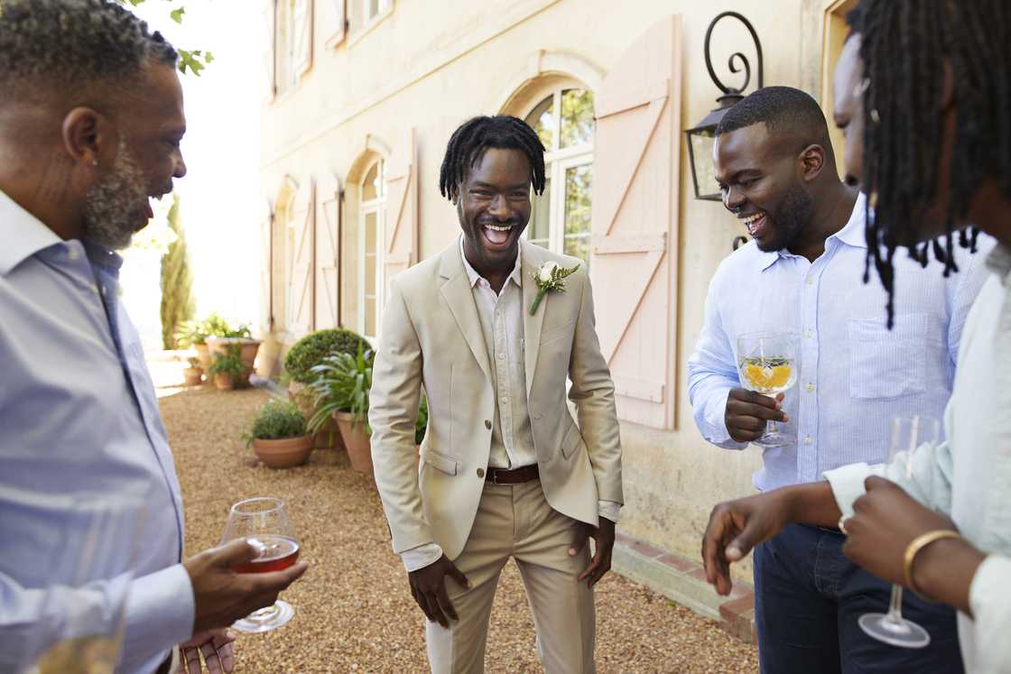Groom enjoying celebration with friends and guests
